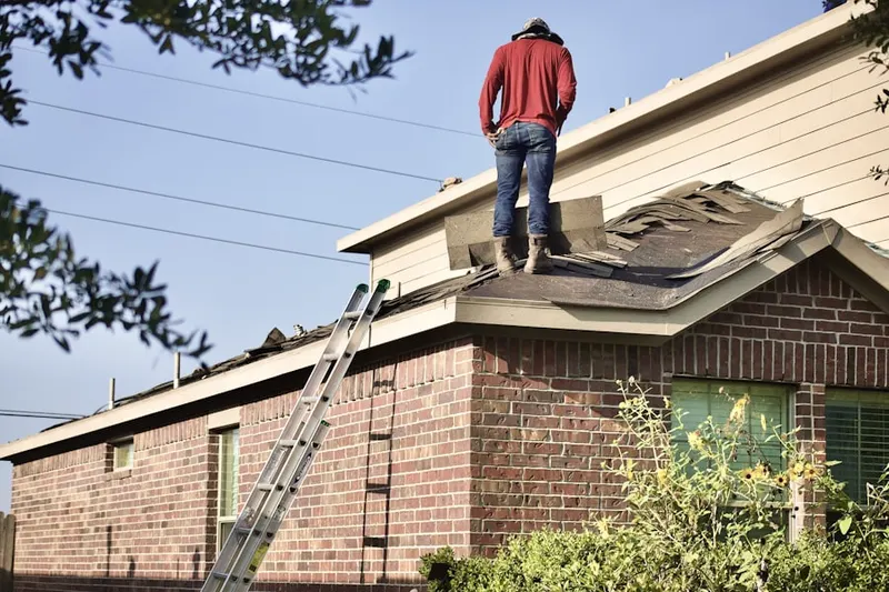 Professional roofer working on a residential roof in Germanton